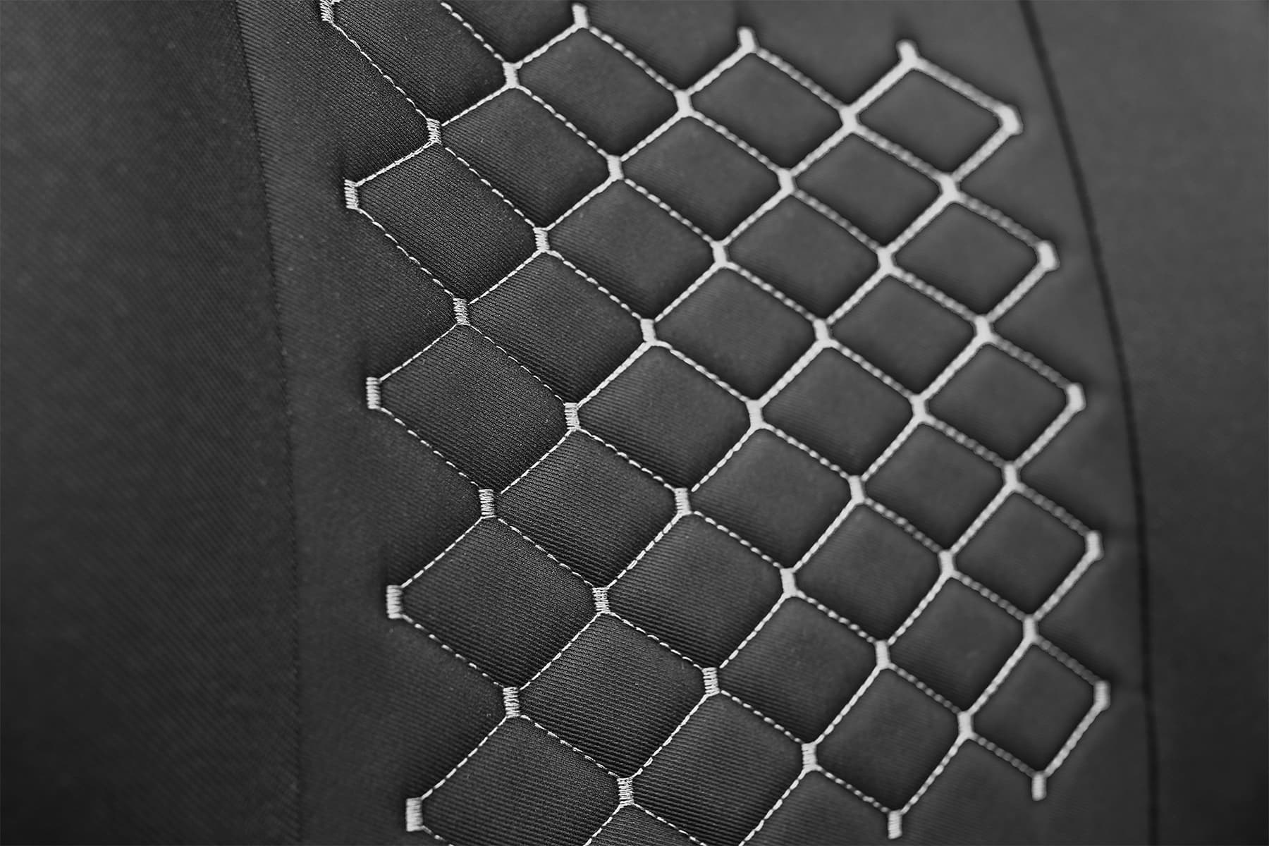 Detail des Polsterstoffs und der grauen Nähte der Motive Autositz-Shirts